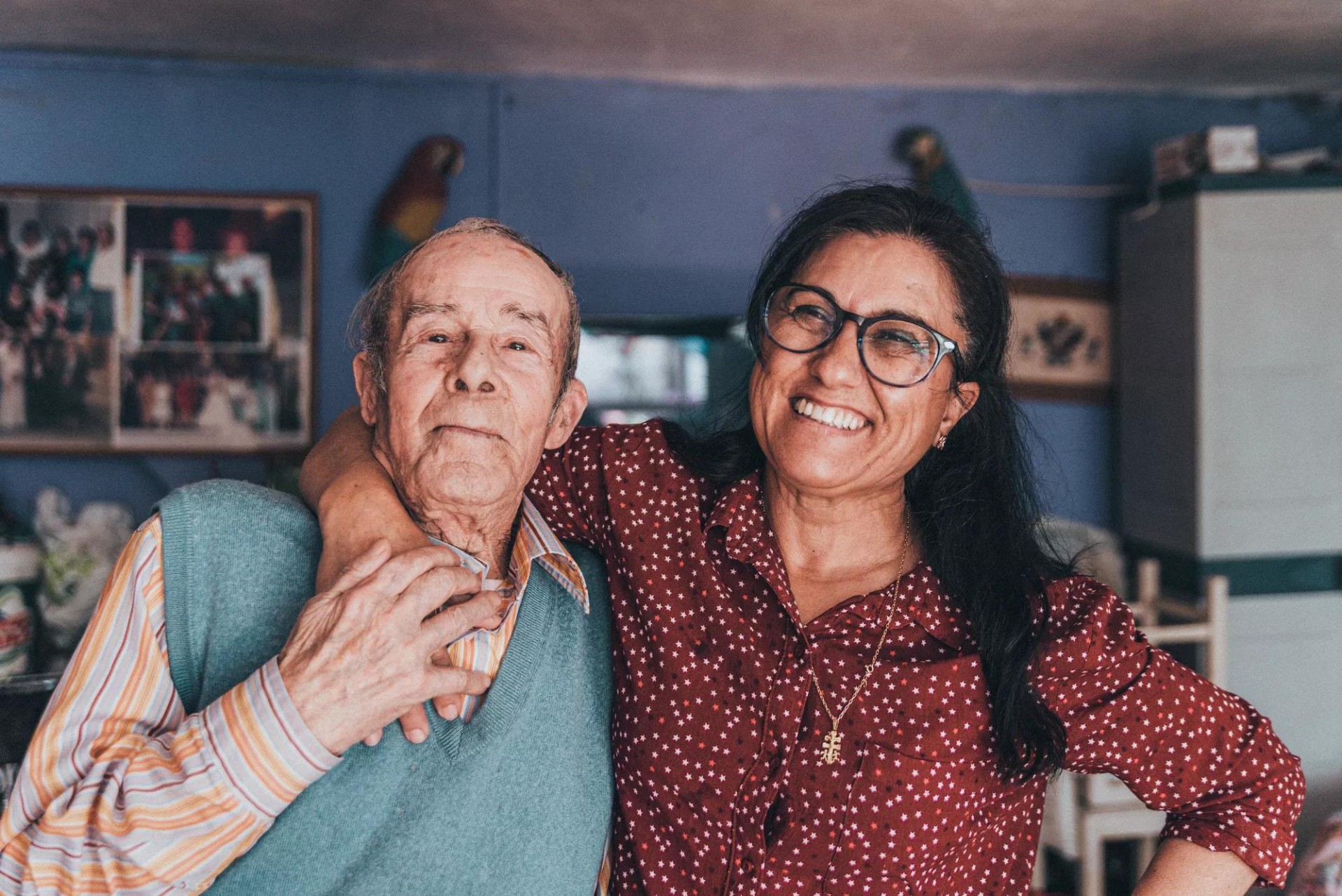 A woman happily hugging a senior companion A woman happily hugging a senior companion