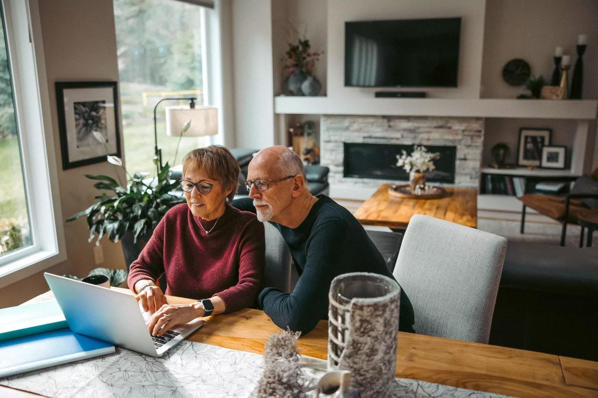 Joyful senior couple browsing dental plan Joyful senior couple browsing dental plan